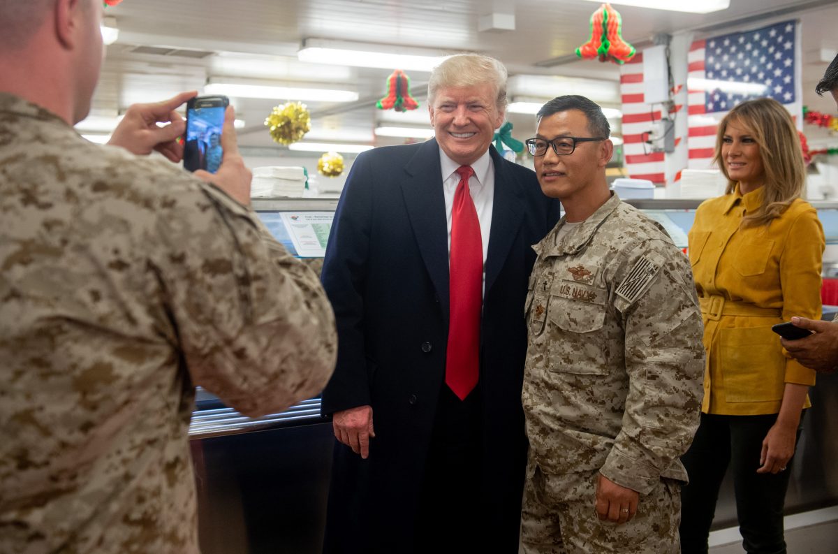 US President Donald Trump and First Lady Melania Trump greet members of the US military during an unannounced trip to Al Asad Air Base in Iraq on December 26 2018  President Donald Trump arrived in Iraq on his first visit to US troops deployed in a war zone since his election two years ago Photo by SAUL LOEB  AFP        Photo credit should