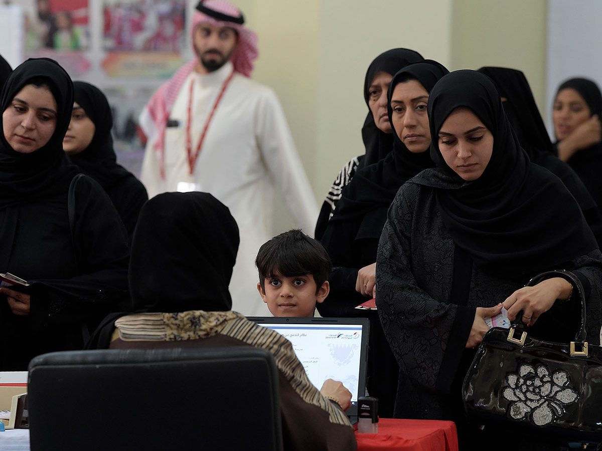 Bahraini voters queue up at a polling station in the Bahraini city of Al-Muharraq, north of Manama on November 24, 2018, as they wait to cast their vote in the parliamentary election.