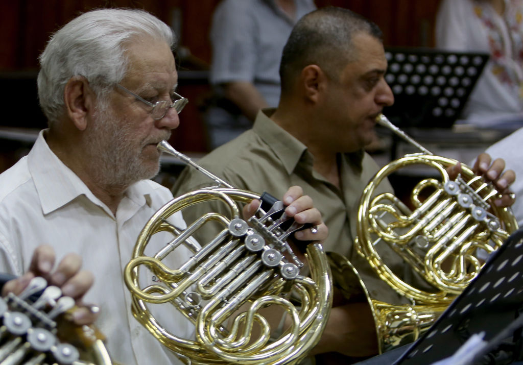 Iraqi National Symphony Orchestra musicians take part in a rehearsal on August 5, 2018 at Baghdad's School of Music and Ballet.  Some 40 musicians are gearing up to play at Baghdad's National Theatre on August 18 but the group's morale is at an all time low. Photo by SABAH ARAR  AFP/Getty Images