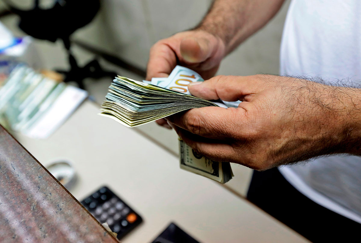 A teller counts US dollars at a currency exchange company in the Lebanese capital Beirut.