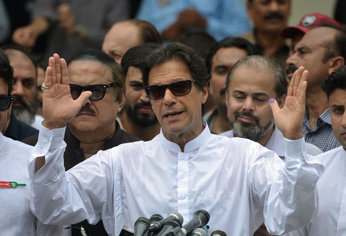 Pakistan's cricketer-turned politician Imran Khan of the Pakistan Tehreek-e-Insaf (Movement for Justice) speaks to the media after casting his vote at a polling station during the general election in Islamabad on July 25, 2018.