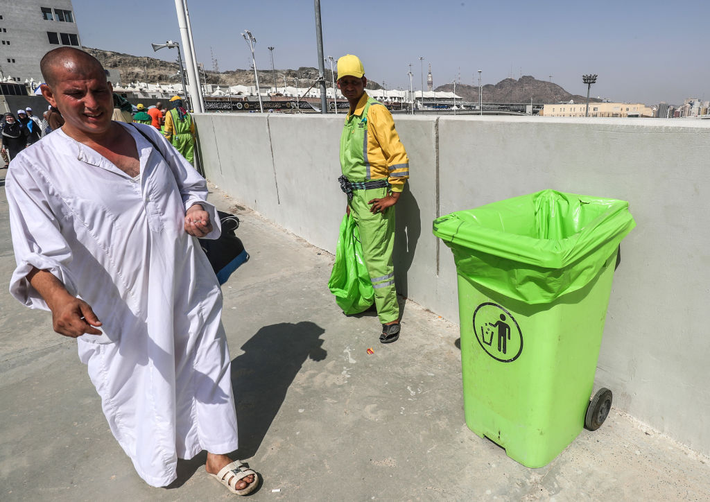 A sanitation worker stands next to a bin while on duty to collect litter during the annual Hajj pilgrimage in the holy city of Makkah. (AHMAD ALRUBAYE/AFP/Getty Images)