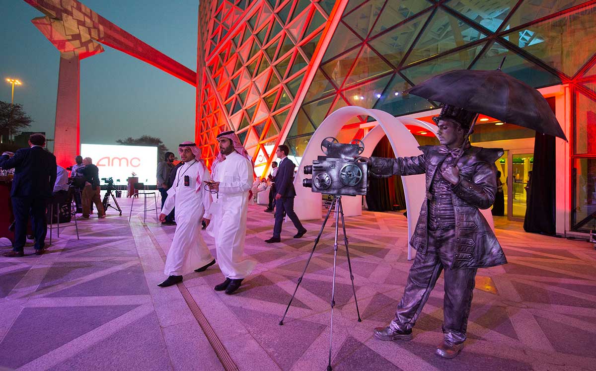 Mime actor standing behind a model vintage cinema camera at the entrance of the AMC cinema in the capital Riyadh ahead of the first test film screening in over three decades.