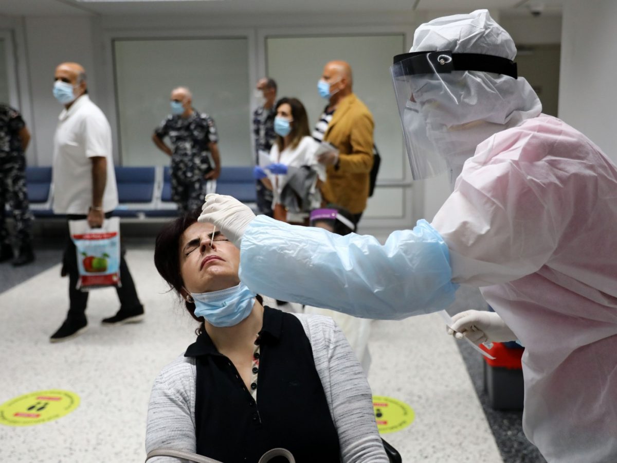 A traveller undergoes a PCR test at Beirut International Airport