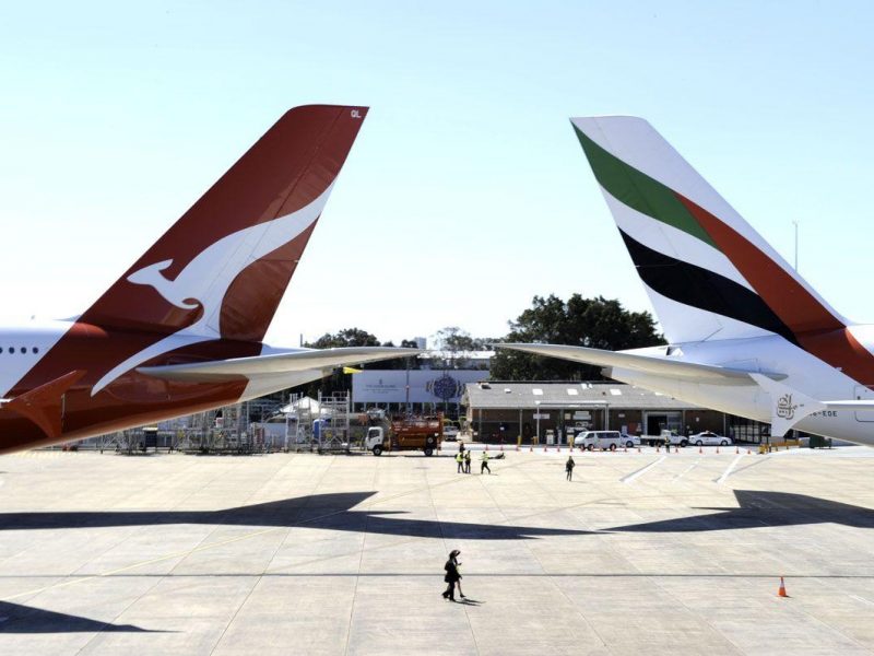 Qantas (L) and Emirates (R) aircraft are pictured on the tarmac of Sydney Airport on September 6, 2012. Struggling Australian carrier Qantas on September 6 announced a major global alliance with Emirates that will see its hub for European flights shift to Dubai from Singapore in a bid to stem losses. (AFP/Getty Images)