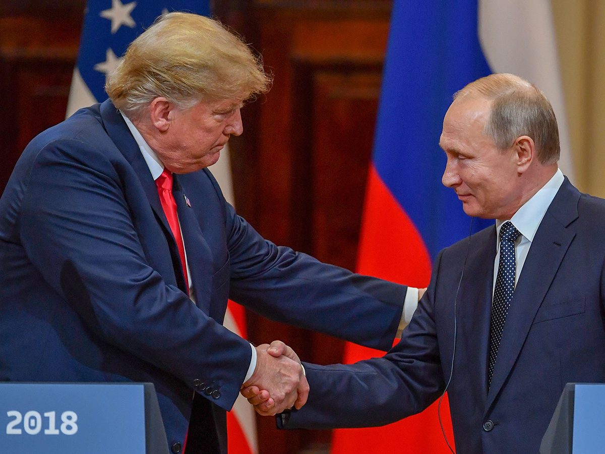 US President Donald Trump (L) and Russia's President Vladimir Putin shake hands before attending a joint press conference after a meeting at the Presidential Palace in Helsinki, on July 16, 2018.