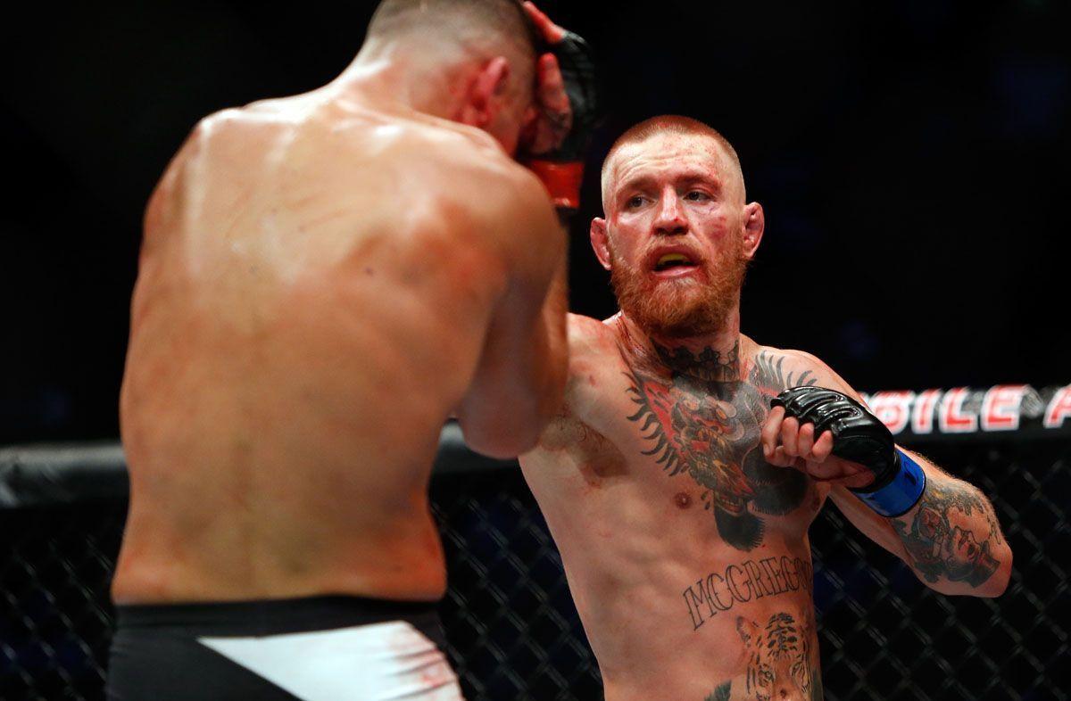 Conor McGregor punches Nate Diaz during their welterweight rematch at the UFC 202 event at TMobile Arena on August 20 2016 in Las Vegas Nevada. The Irishman returns to the octagon to fight Khabib Nurmagomedov on October 6. Photo by Steve Marcus/Getty Images.