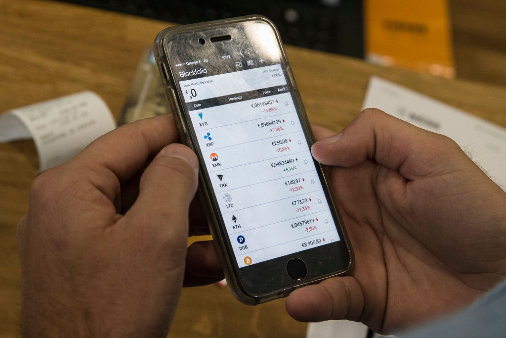 A mobile phone displaying virtual currencies exchange rates.  Saudi standing committee that not only are these activities all outside the scope of government supervision, but that cryptocurrencies have also been used for a variety of illicit activity.
Photo: GEOFFROY VAN DER HASSELT/AFP/Getty Images.