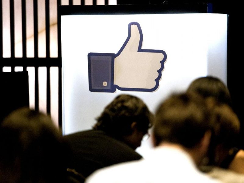 Journalists sit in front of an illuminated "like" symbol from the Facebook Inc. social networking website during a news conference at the Armani Hotel to announce the opening of a Facebook office in Dubai, United Arab Emirates, on Wednesday, May 30, 2012. Facebook Inc, which raised $16 billion this month in the biggest initial share sale f