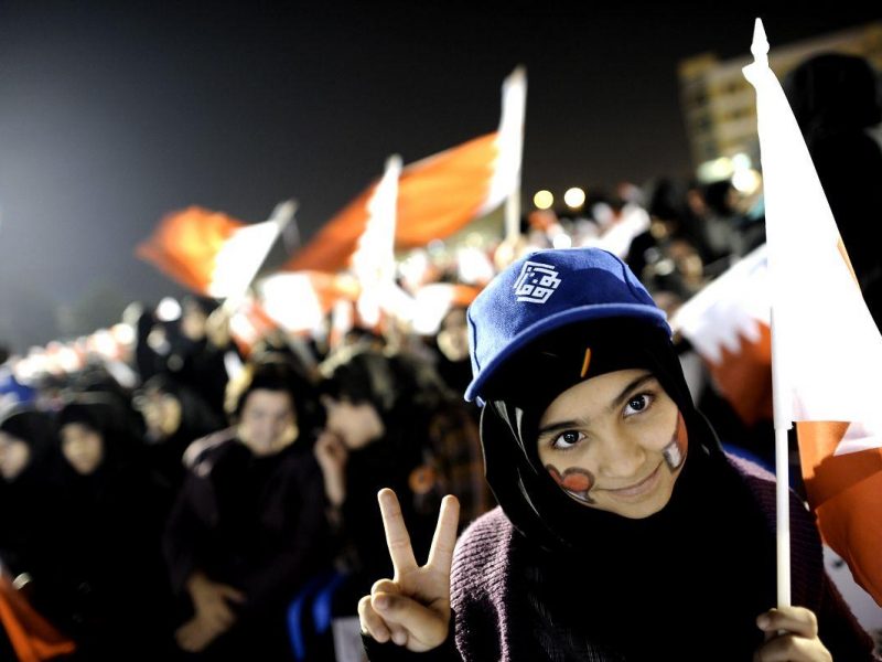 A Bahraini Shiite girl makes the victory sign during an anti-government rally