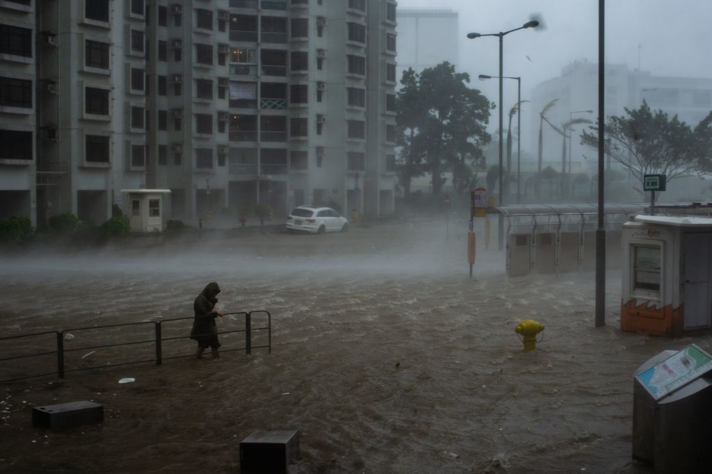 A man wades across the floods in Heng Fa Chuen, Hong Kong, during the approach of super Typhoon Mangkhut.
Photo: PHILIP FONG/0AFP/Getty Images.