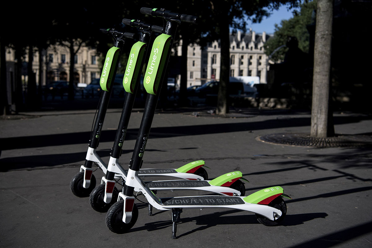 Electric scooters of the US company Lime are pictured on a sidewalk in Paris during their launching day on June 22, 2018. (Photo by Christophe ARCHAMBAULT / AFP) (Photo credit should read CHRISTOPHE ARCHAMBAULT/AFP/Getty Images)