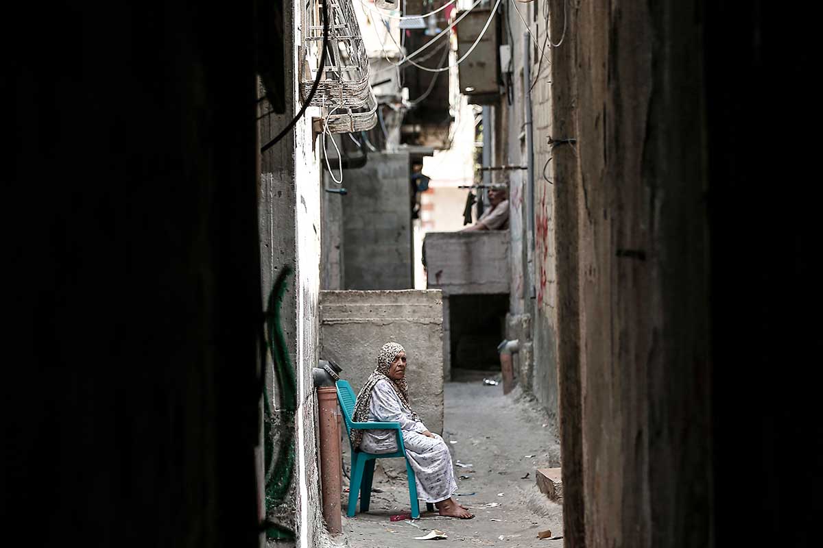 A Palestinian refugee sits in a street of the Al-Shati refugee camp, in Gaza City on September 1, 2018.