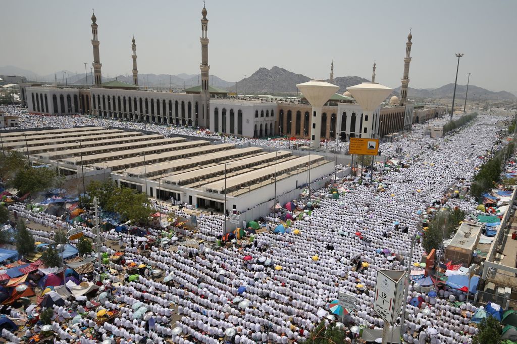 Muslim worshippers some carrying umbrellas to protect them from the scorching sun gather for prayer at Namirah mosque near Mount Arafat. (KARIM SAHIB/AFP/Getty Images)