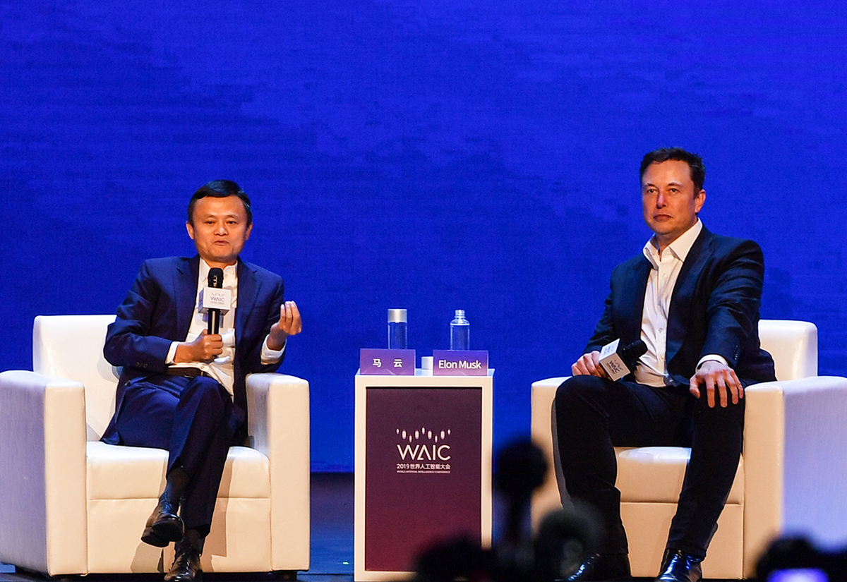 Elon Musk (R), Co-founder and CEO of Tesla, and Jack Ma, co-chair of the UN High-Level Panel on Digital Cooperation, speak onstage during the the World Artificial Intelligence Conference (WAIC) in Shanghai on August 29, 2019.