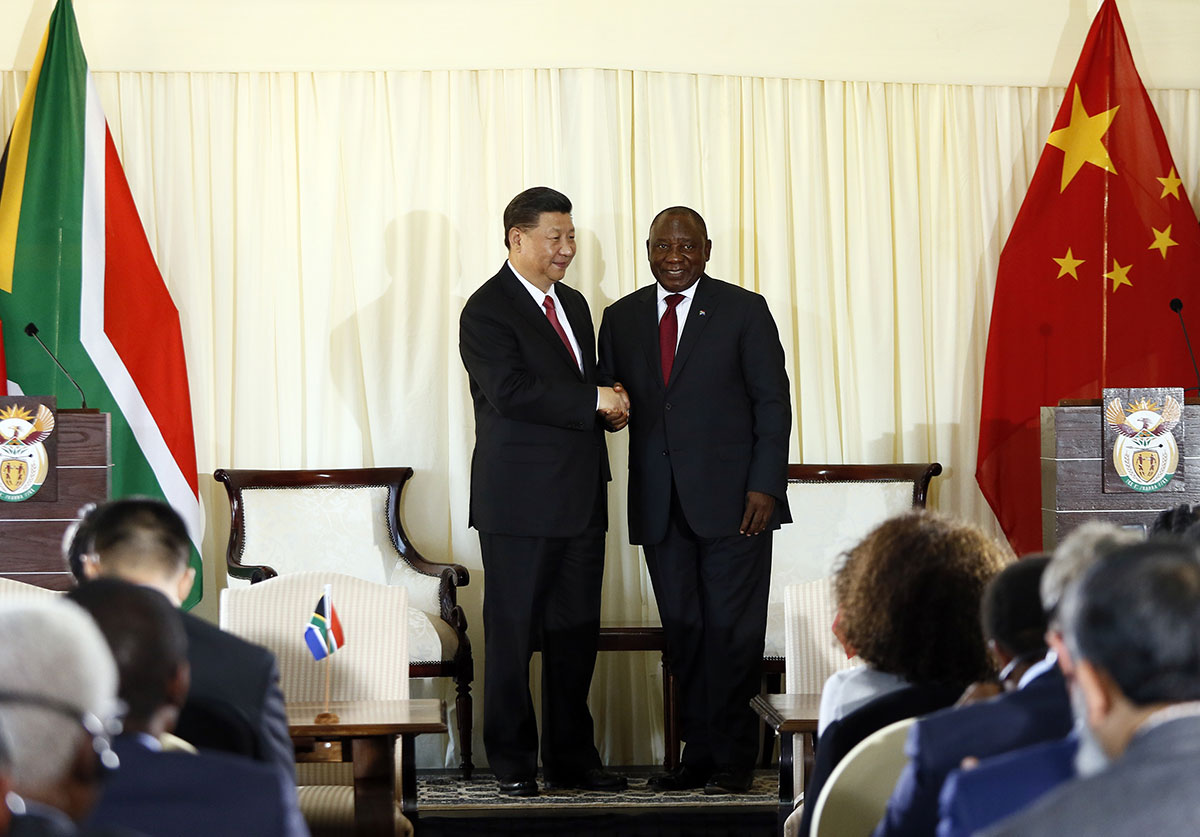 Chinese President Xi Jinping (L) and South African President Cyril Ramaphosa shake hands after a press conference following their meeting at the Union Building in Pretoria, on July 24, 2018.