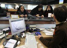 A bank clerk deals with customers at Bank Mellat. (Getty Images -for illustrative purposes only)