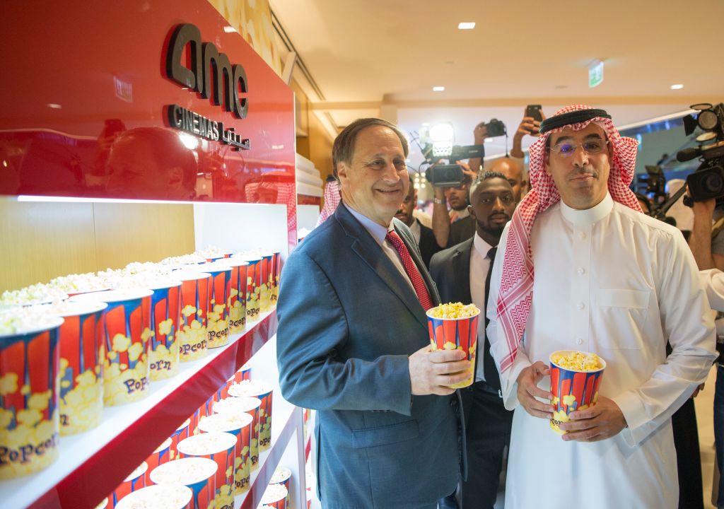 Saudi Information Minister Awwad Alawwad (right) and AMC Entertainments chief executive Adam Aron posing for a photograph with small popcorn buckets at the AMC cinema in Riyadh.
Photo: BANDAR ALJALOUD/AFP/Getty Images.