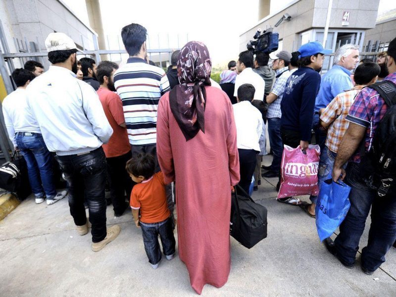 Syrian refugees wait at Cilvegozu border gate to go back to Syria after car bombings at Reyhanli in Hatay, on May 14, 2013. (AFP/Getty Images)