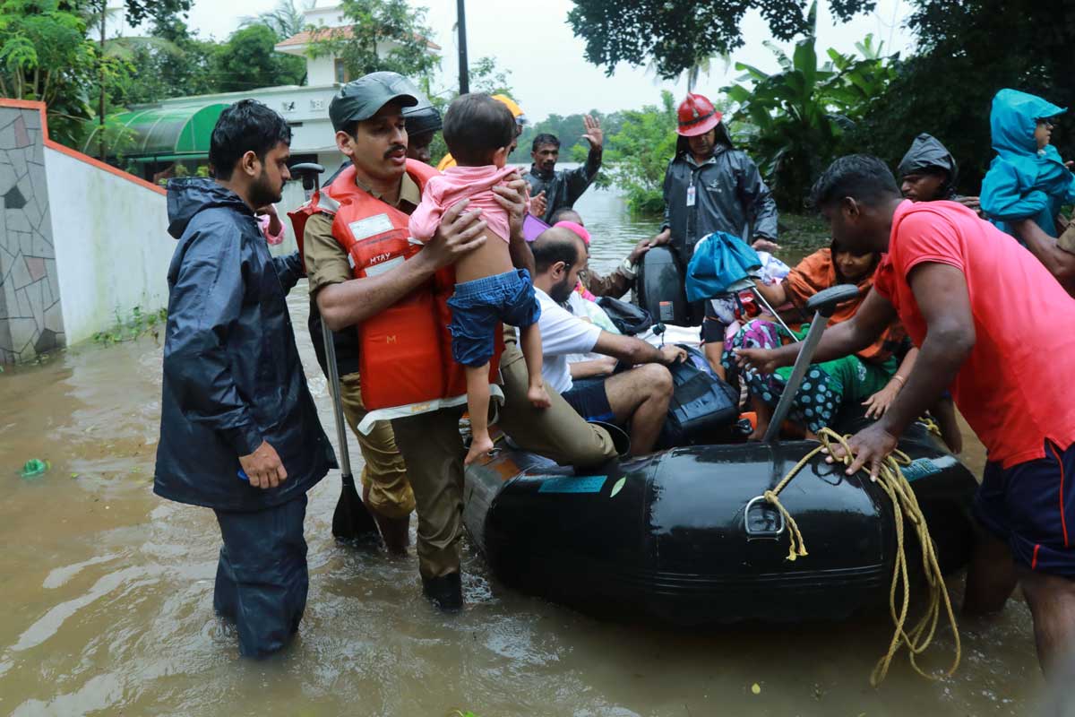 Fire and Rescue personnel evacuate local residents in an inflatable boat from a flooded area at Muppathadam near Eloor in Kochi's Ernakulam district, in the Indian state of Kerala on August 15, 2018. (Getty Images)