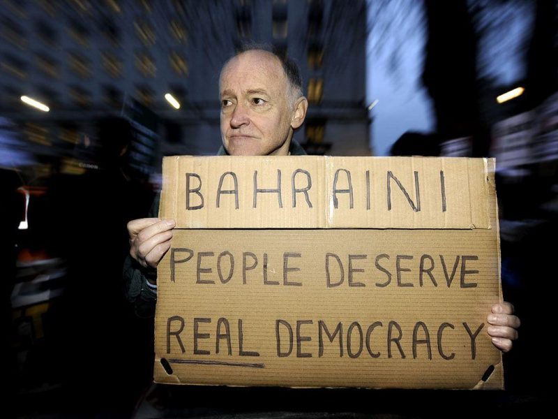 A UK protestor holds a placard in support of demonstrators lobbying for political change in Bahrain