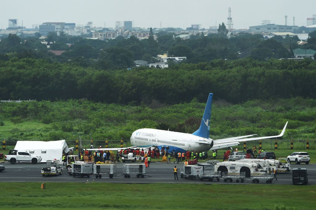 A Xiamen Airlines Boeing 737-800 series passenger aircraft operating as flight MF8667 from Xiamen to Manila is seen after skidding off the runway while attempting to land in bad weather at the Manila international airport on August 17 2018  Some 157 passengers and eight crew were evacuated from the aircraft with no reported injuries.
Phot