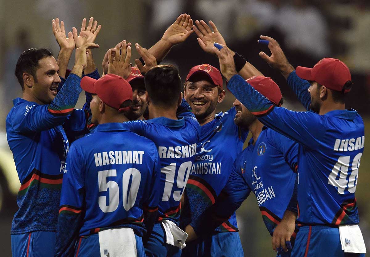 Afghan cricketer Mohammad Nabi (left) celebrates with teammates after he dismissed Sri Lanka's cricket team captain Angelo Mathews during the one day international (ODI) Asia Cup cricket match between Sri Lanka and Afghanistan at the Sheikh Zayed Stadium in Abu Dhabi on September 17, 2018.