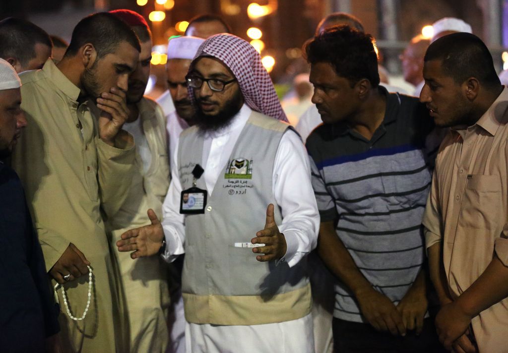 Muslim pilgrims speak to a translator in the Saudi holy city of Mecca ahead of the start of the Hajj pilgrimage on August 17 2018 
All photos: AHMAD ALRUBAYE/AFP/Getty Images.