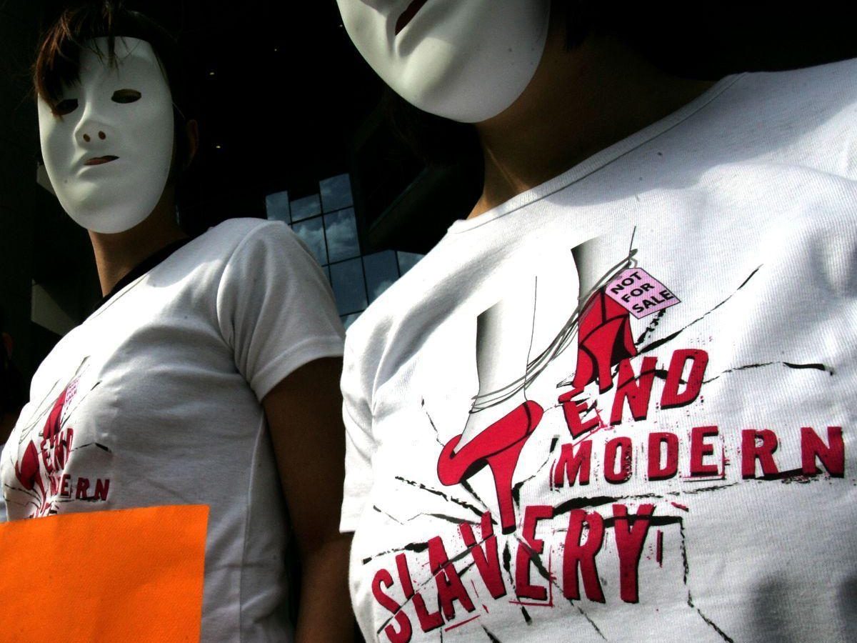 Amnesty International activists wearing T-shirts reading end modern slavery protest against human trafficking near the Ministry of Justice in Athens on March 7, 2008 a day before the International Women Day. According to Amnesty International, Greece has been a transit and destination country for trafficked persons since the early 1990s. A