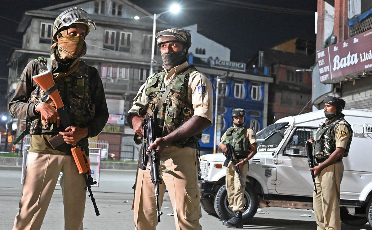 Indian paramilitary troopers stand guard at a roadblock at Maisuma locality in Srinagar on August 4, 2019.