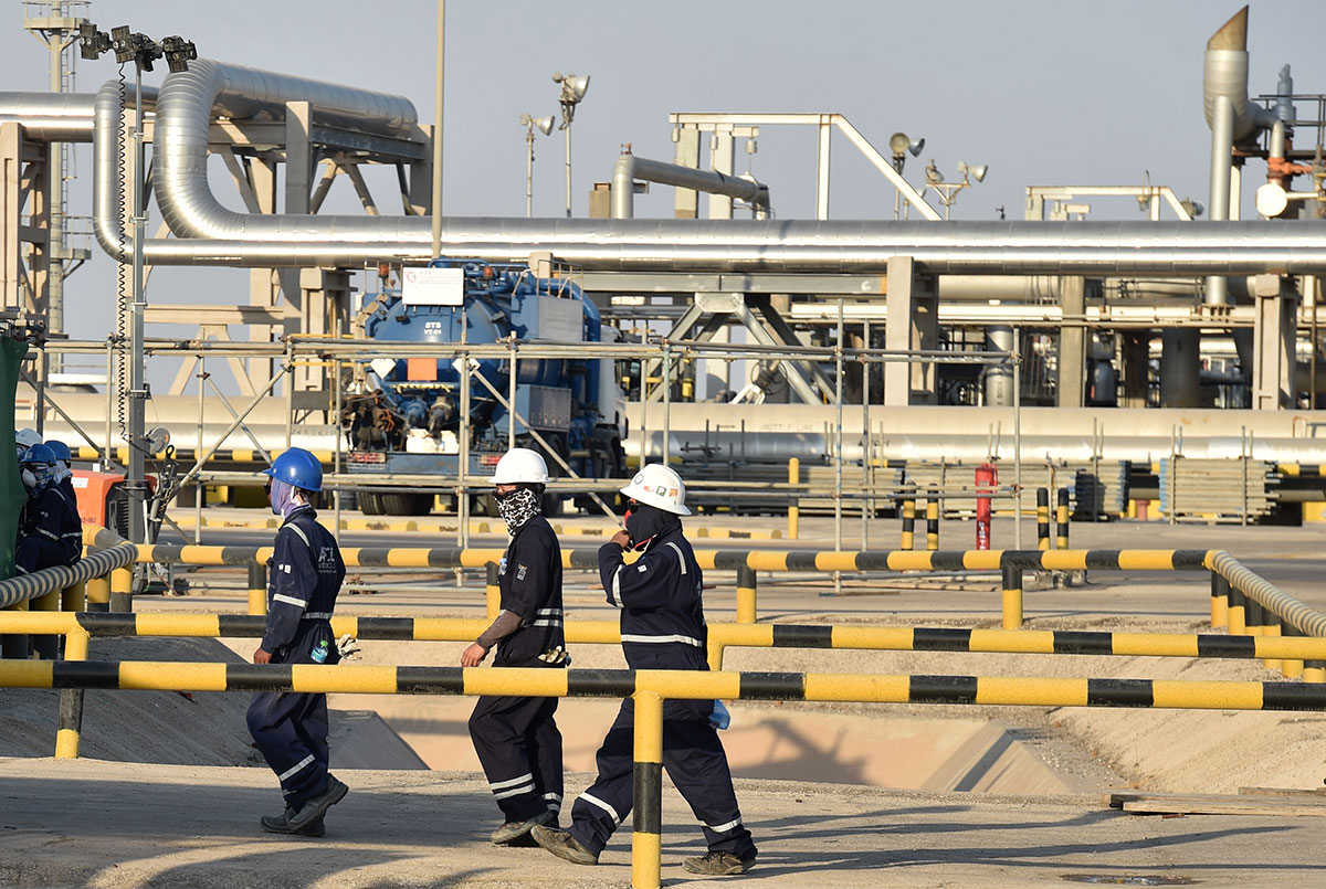 Employees of Aramco oil company work in Saudi Arabia's Abqaiq oil processing plant.