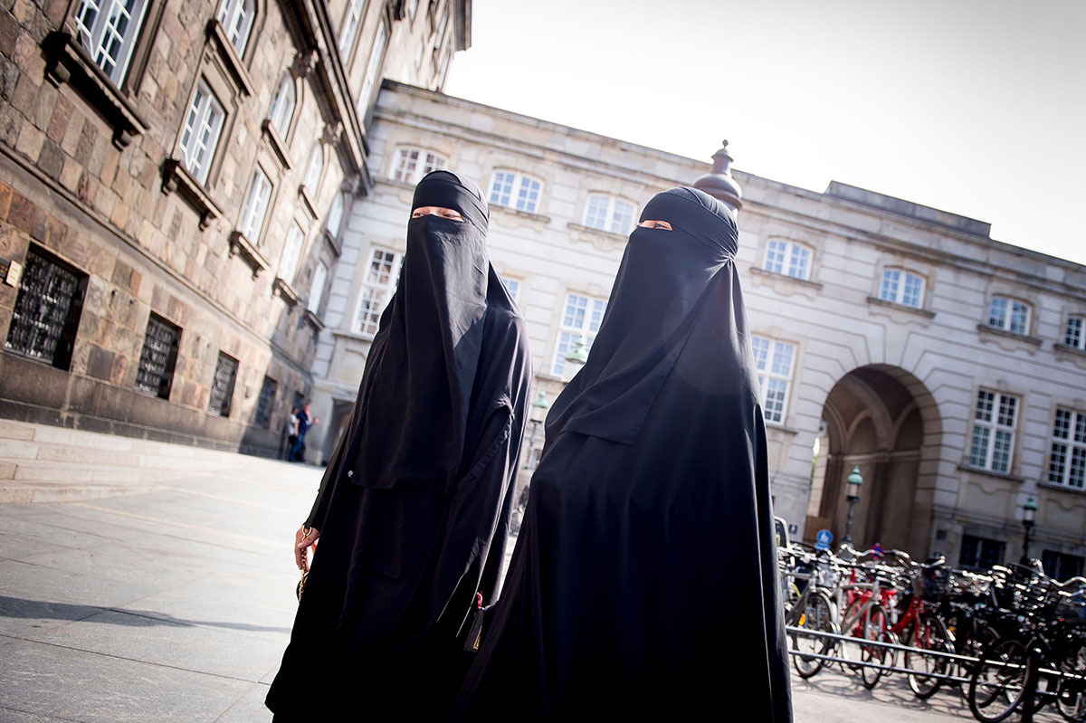 Women wearing niqab are pictured in front of the Danish Parliament in Copenhagen, Denmark, on May 31, 2018.