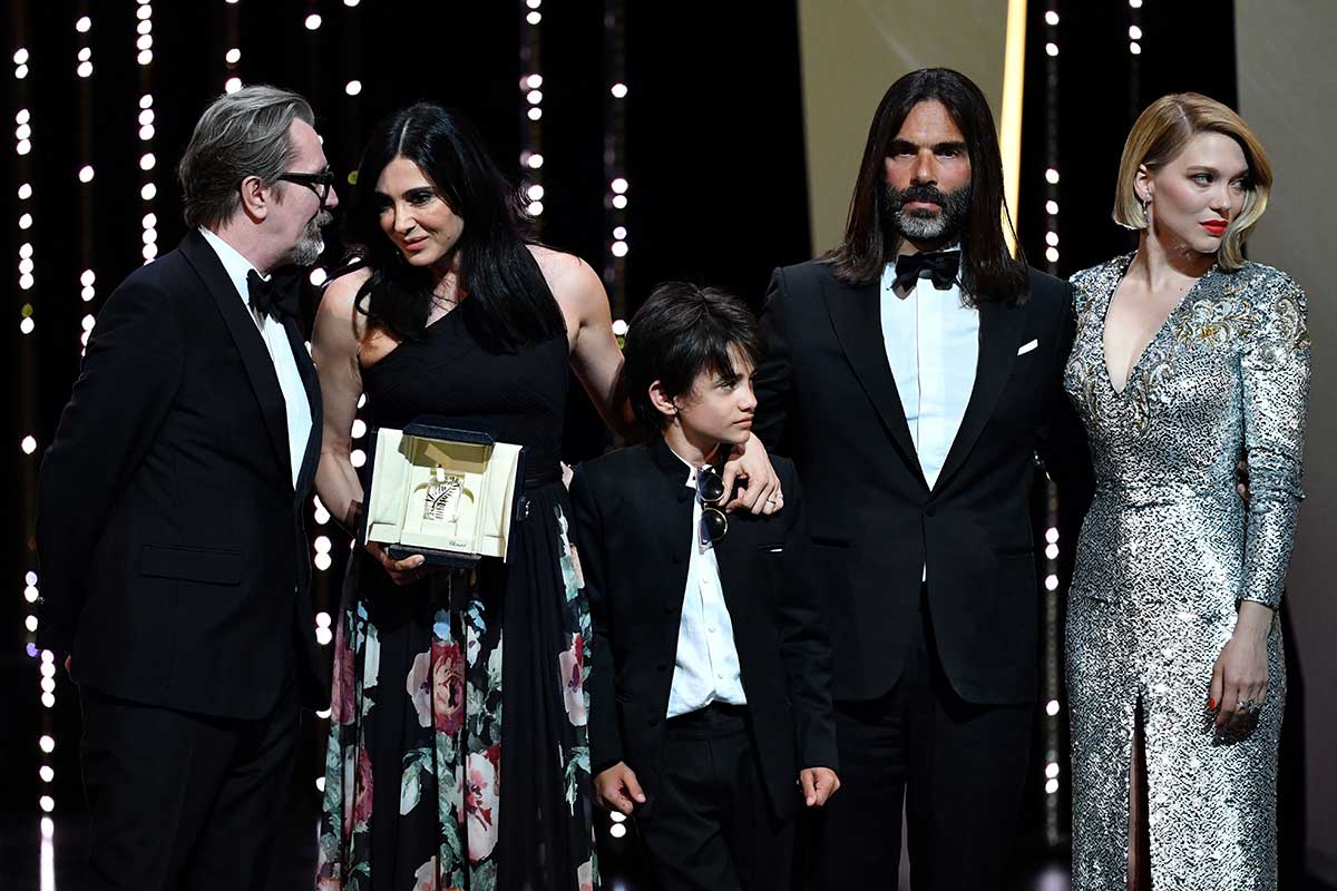 Lebanese director and actress Nadine Labaki (L) delivers a speech on stage next to Syrian actor Zain al-Rafeea (C) and her husband Lebanese producer Khaled Mouzanar (3rdR), British actor Gary Oldman (2ndR) and French actress and member of the Feature Film Jury Lea Seydoux after she was awarded with the Jury Prize for the film 'Capharnaum'