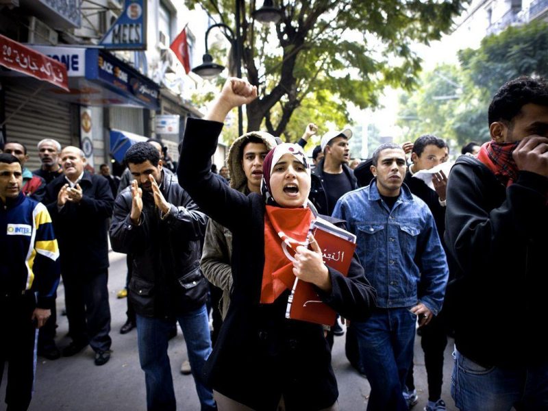 UP IN ARMS: People shout slogans to protest corruption, repression and rising levels of unemployment in Tunisia