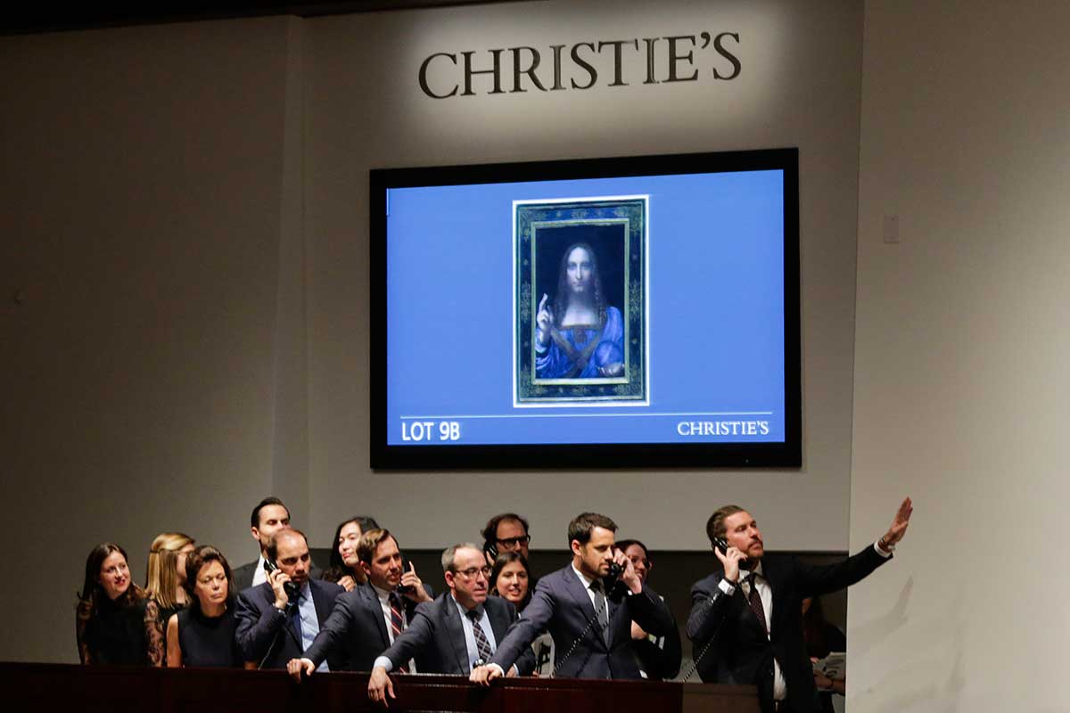 Agents speak on their phones with their clients while bidding on at the auction of Leonardo da Vinci's 'Salvator Mundi' during the Post-War and Contemporary Art evening sale at Christie's on November 15, 2017 in New York City. 
(Photo by Eduardo Munoz Alvarez/Getty Images)