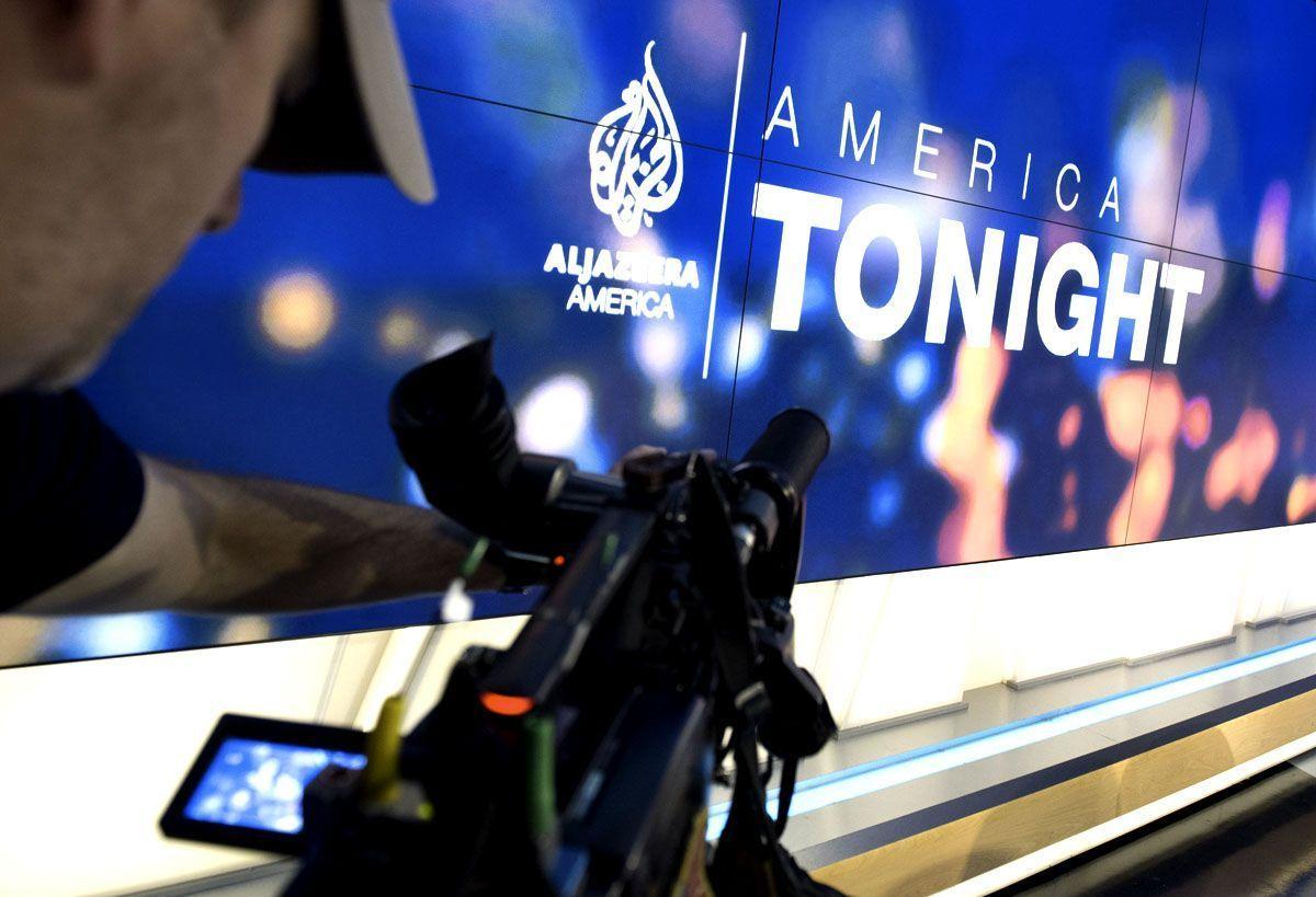 A news photographer films the logo of the new Al Jazeera America nightly news program America Tonight. (SAUL LOEB/AFP/Getty Images - for illustrative purposes only)