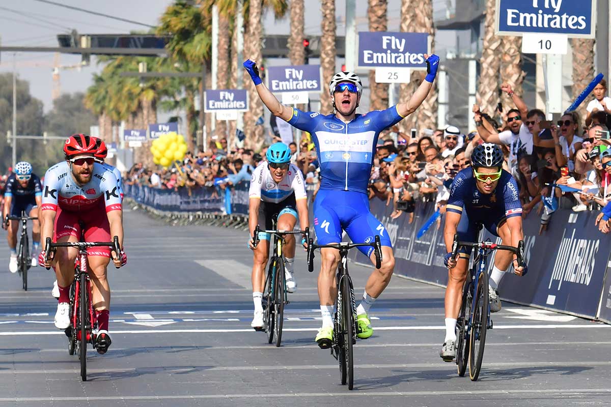 Quick-Step Floors' Italian rider Elia Viviani (C) celebrates after crossing the finish line of the fifth stage of the Dubai Tour from Sky Dive Dubai to Dubai City Walk.