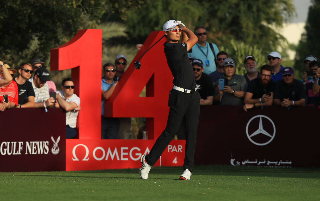 Haotong Li of China tees off on the 14th hole during day three of Omega Dubai Desert Classic at Emirates Golf Club. (Andrew Redington/Getty Images)