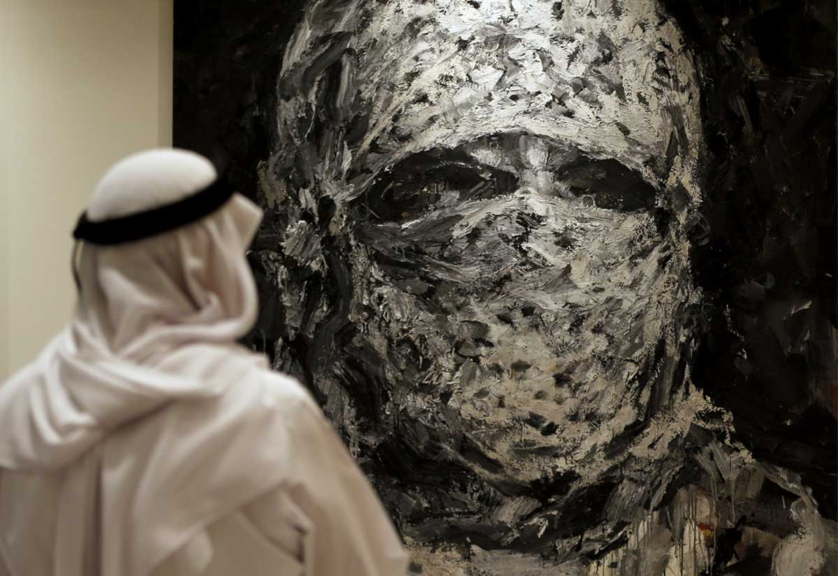 A man looks at a painting by Lebanese artist, Ayman Baalbaki at Christie's Auction house in Dubai.