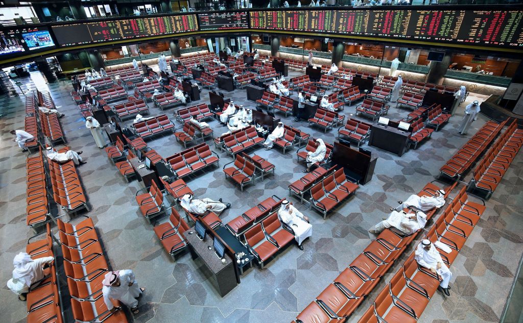 Kuwaiti traders follow stock market activity as they sit in the main hall at the Kuwait Stock Exchange Boursa headquarters in Kuwait City .
  Photo: YASSER ALZAYYAT/AFP/Getty Images