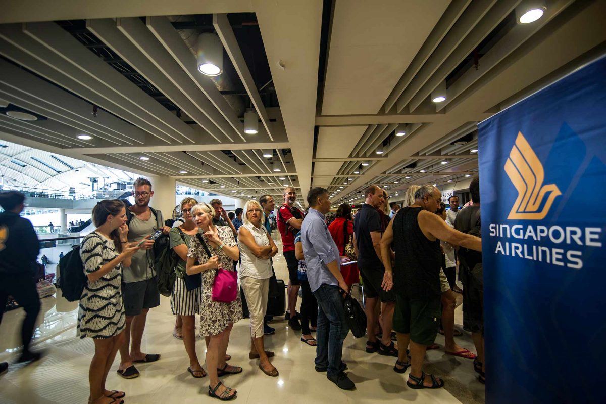 Passengers gather at the Ngurah Rai International airport in Denpasar, Bali. (JUNI KRISWANTO/AFP/Getty Images)