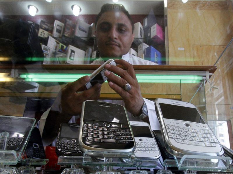 A Saudi man displays mobile phones at his mobile shop in the Saudi Red Sea port of Jeddah. (Getty Images)