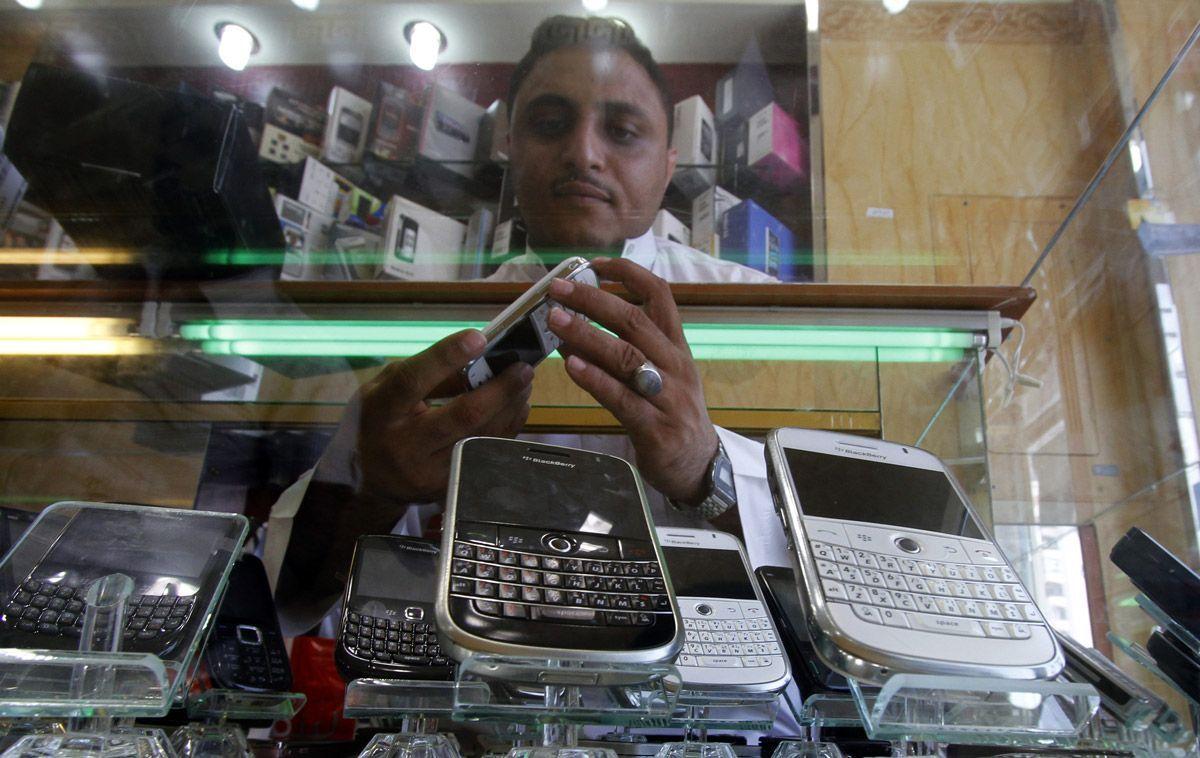 A Saudi man displays mobile phones at his mobile shop in the Saudi Red Sea port of Jeddah. (Getty Images)