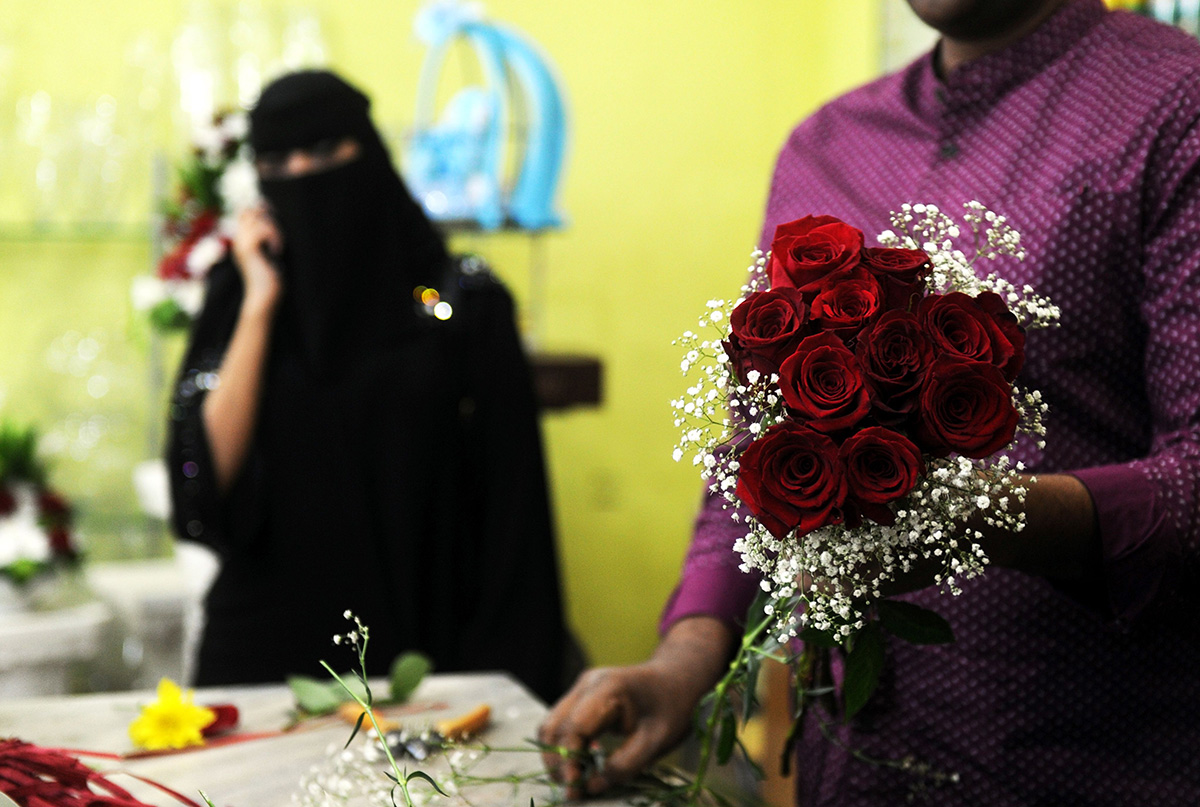 A florist prepares a Valentine's Day bouquet of flowers for a Saudi client at a flower shop in Jeddah on February 14, 2018.