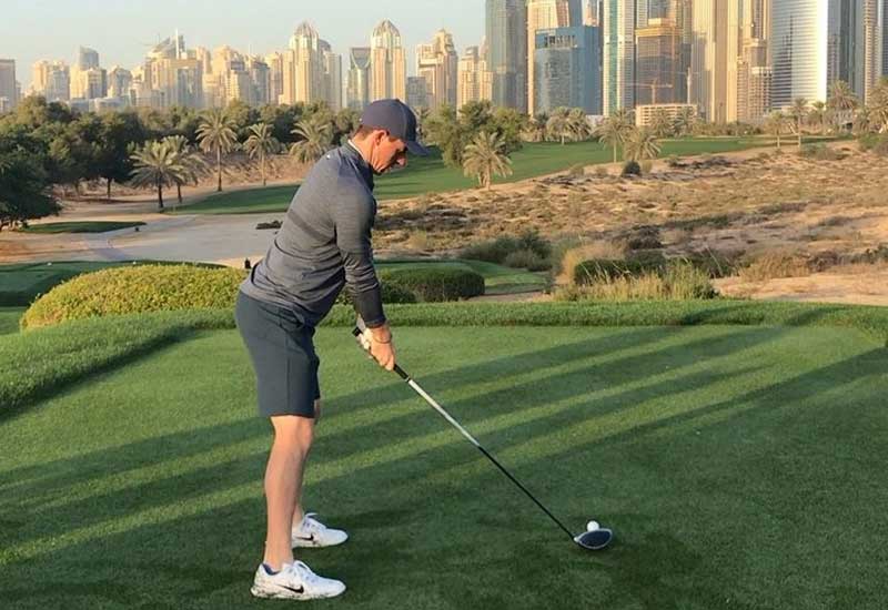 Rory McIlroy teeing off at Emirates Golf Club in Dubai.