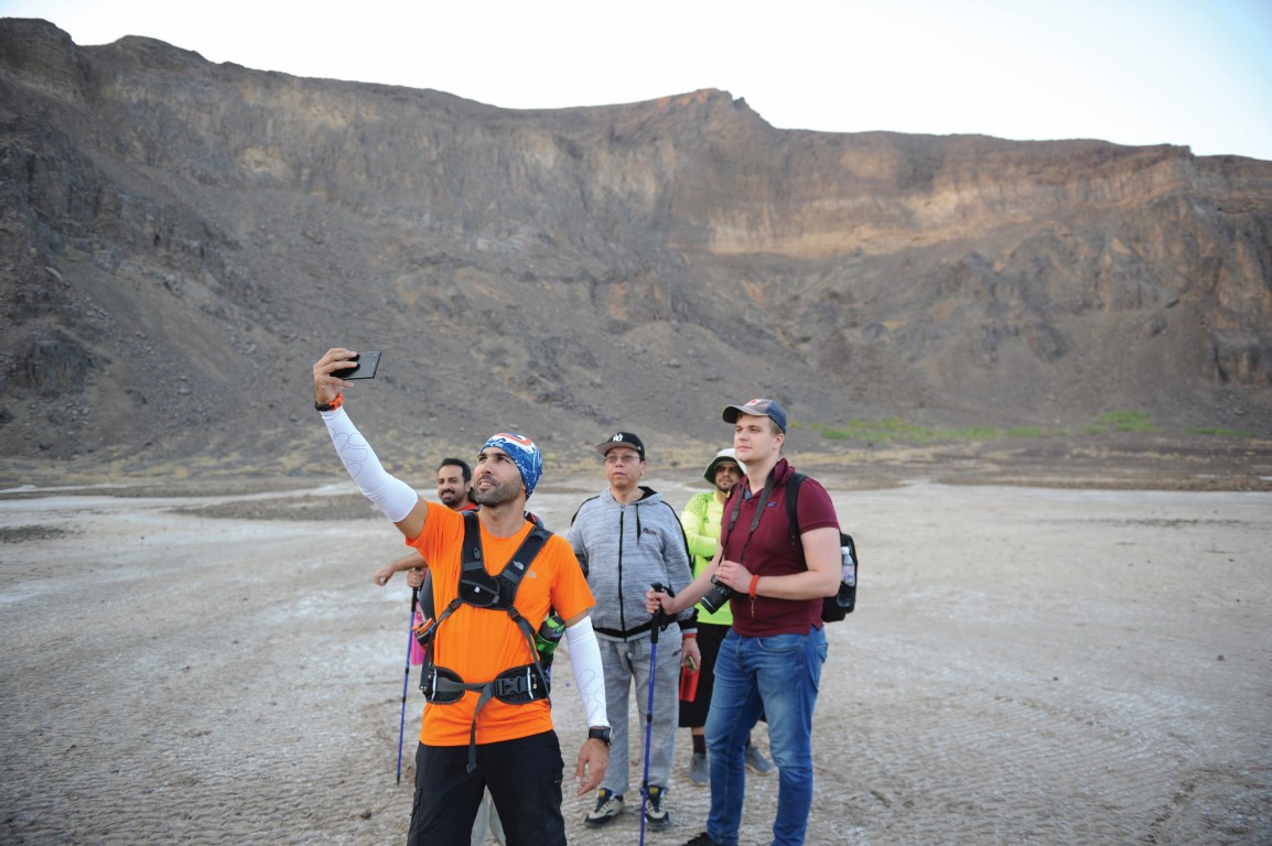 A Saudi guide takes a selfie as he leads a group of foreign tourists through the Al Wahbah volcanic crater in the Al Wahbah desert some 360 kms northeast of Jeddah.