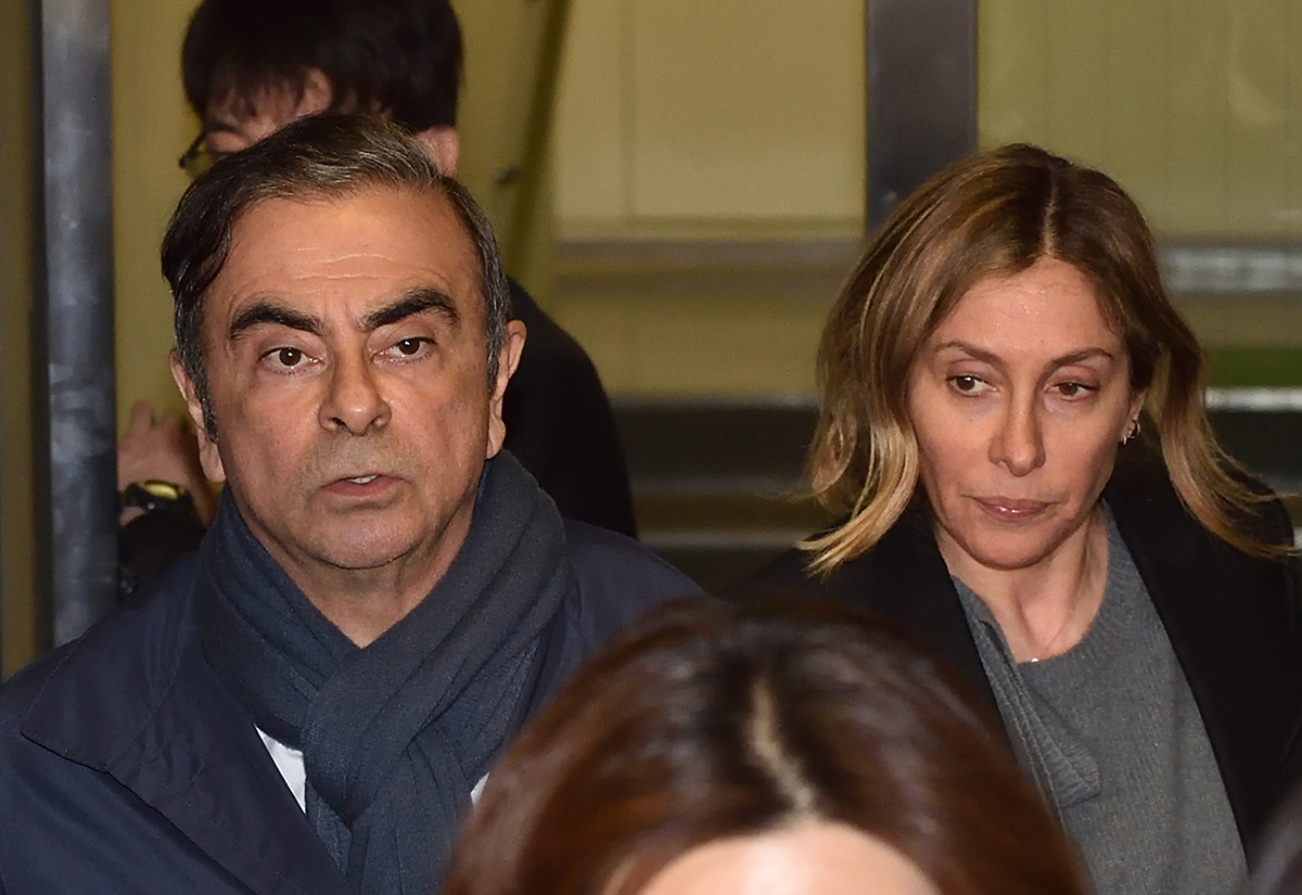 Former Nissan Chairman Carlos Ghosn (L) and his wife Carole (R) leave the office of his lawyer Junichiro Hironaka in Tokyo on April 3, 2019.