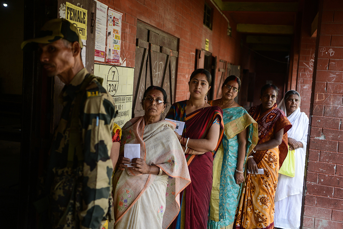 People line up to vote at a polling station during India's general election in Cooch Behar, West Bengal on April 11, 2019.