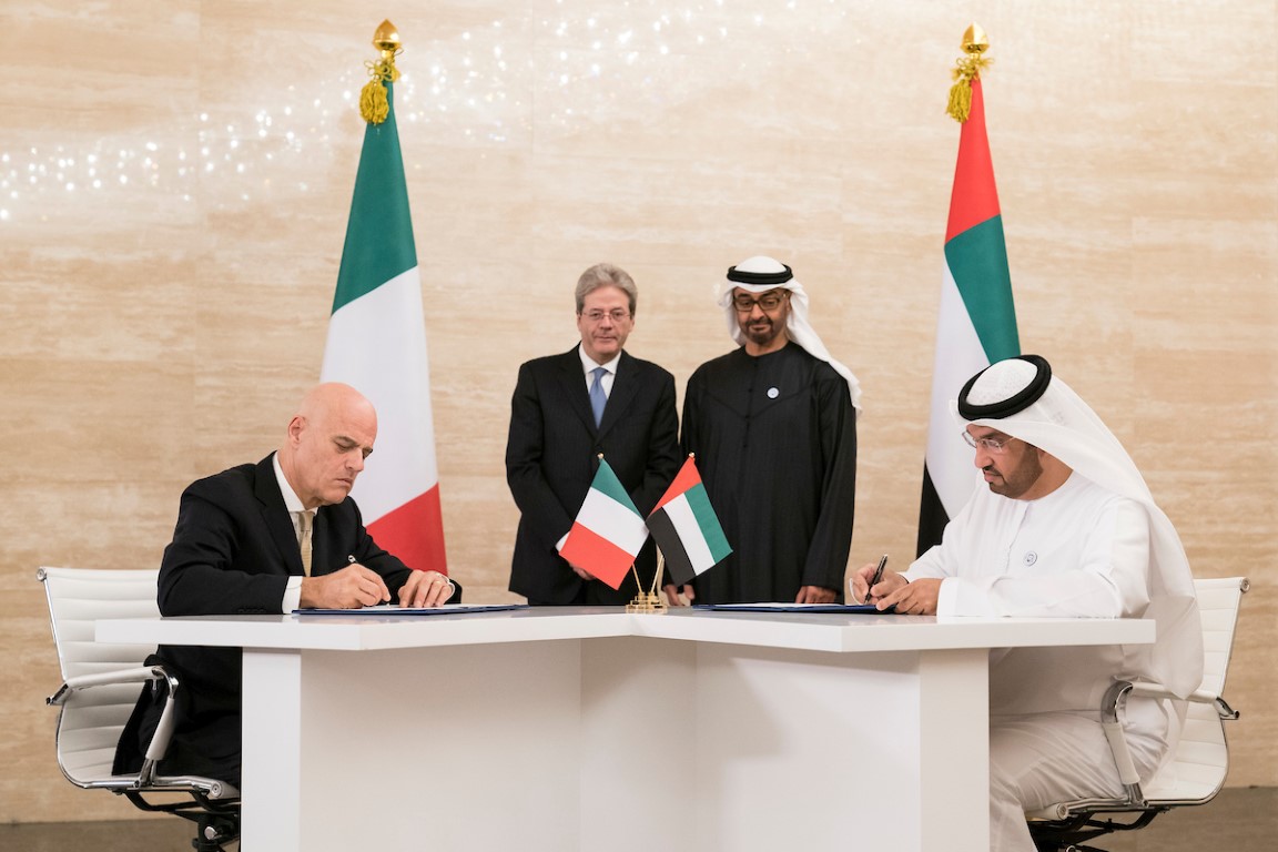 Dr. Sultan Ahmed Al Jaber (front right), ADNOC Group CEO, and Claudio Descalzi (front left), CEO of Eni, sign historic agreements awarding Eni stakes in two of Abu Dhabi’s offshore concessions, witnessed by Sheikh Mohamed, Crown Prince of Abu Dhabi (back center right), and  Paolo Gentiloni, Prime Minister of Italy (back center left).