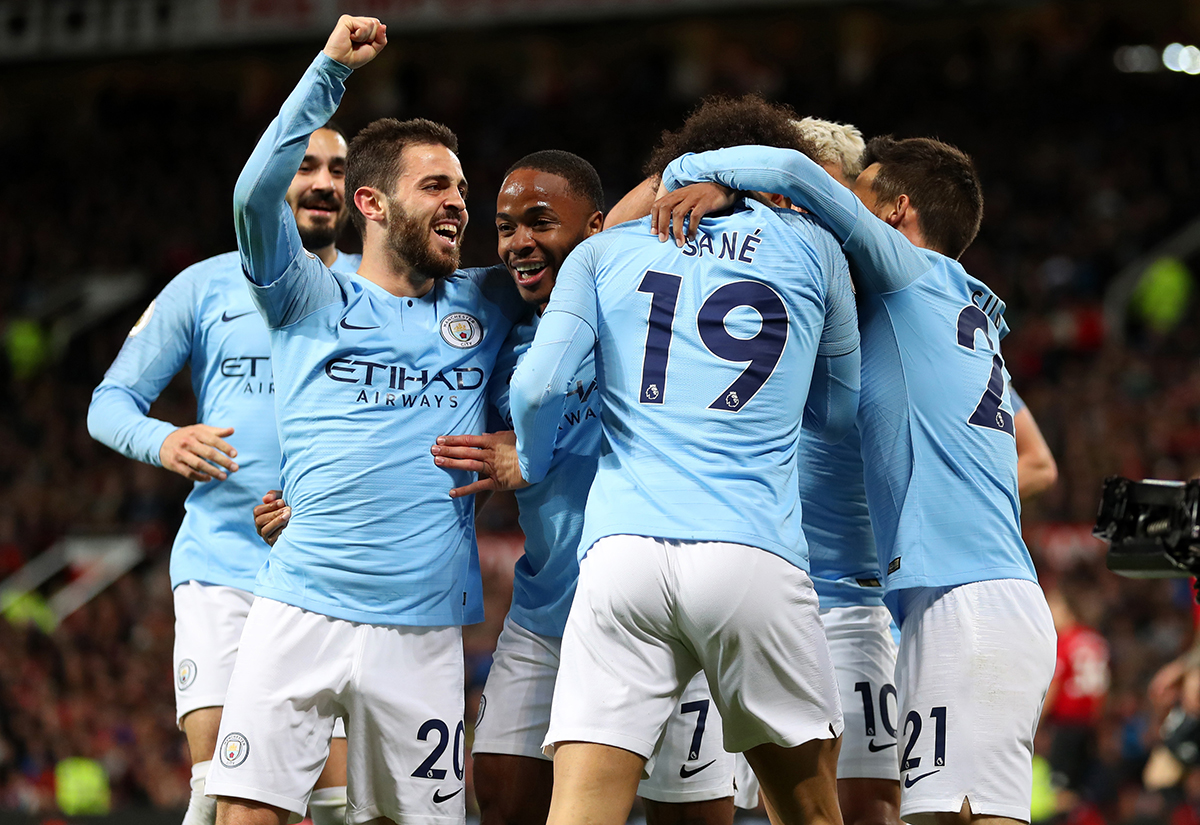 Leroy Sane of Manchester City celebrates with teammates Bernardo Silva and Raheem Sterling after scoring his team's second goal during the Premier League match between Manchester United and Manchester City at Old Trafford on April 24, 2019 in Manchester, United Kingdom.